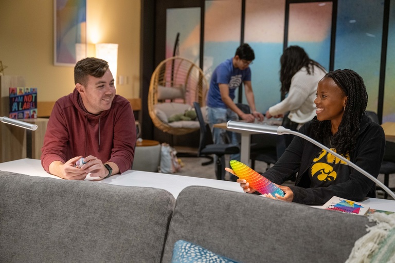Students talking and smiling in the student disability services lounge