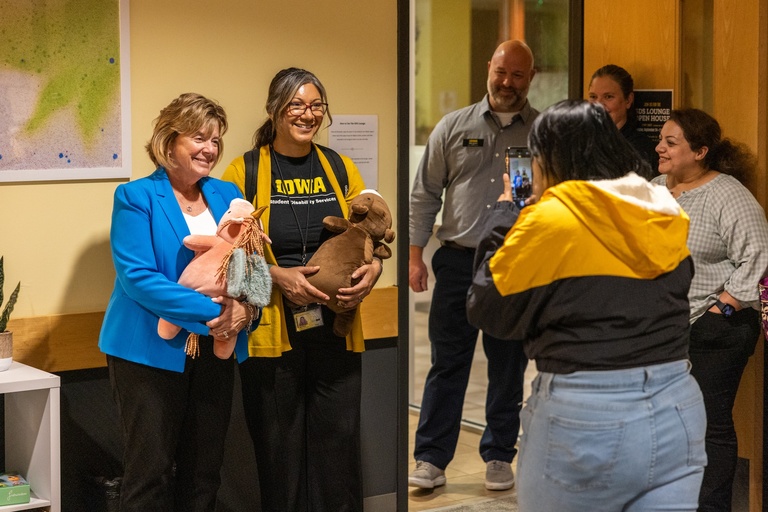 President Wilson and Dr. Maria Bruno posing for photos while holding weighted stuffed animals