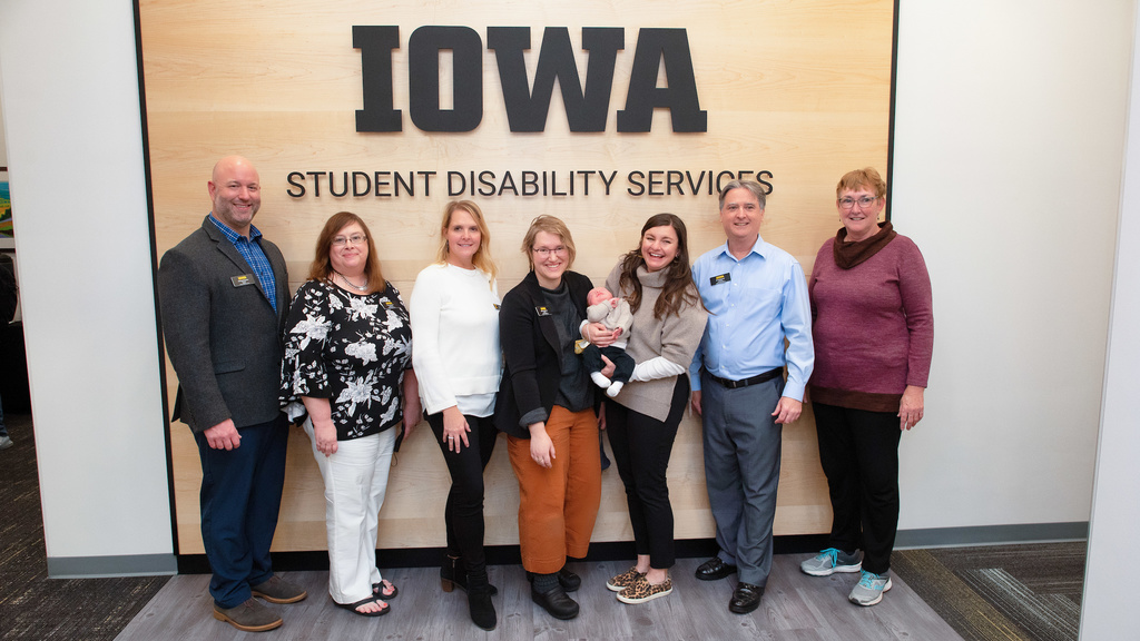 staff members standing in front of Student Disability Services sign